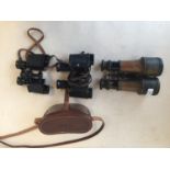 Quantity of vintage binoculars, worn