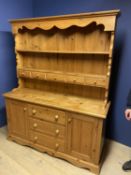 Pine dresser, 3 drawers to base flanked by two cupboards, 83cm H base, plus 110 cm H top x 156cm W x