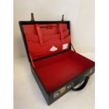 Black attaché case, with red fitted interior