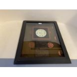 Jade pierced disk 11/5cm diam in a large glazed frame