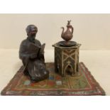 Cold painted bronze kneeling figure on a rug as an inkwell, 7cm H