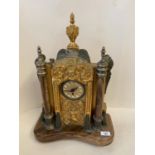 A German mantle clock, the circular face surmounted within an ornate gilded/ormolu embossed rococo