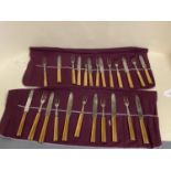 Set of 12 campaign bronze handled knives and forks and another set of 12 pistol grip knives and