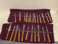 Set of 12 campaign bronze handled knives and forks and another set of 12 pistol grip knives and