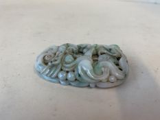 A very finely carved jade pendant with mythical dragons and sea serpents, 6cmL