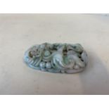 A very finely carved jade pendant with mythical dragons and sea serpents, 6cmL