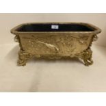 Good gilded bronze oblong jardiniere, with relief decoration of exotic birds, the 4 feet of mythical