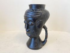 Congolese Kuba carved wine cup, with three typical stylised faces and figural handle 8.5” inches