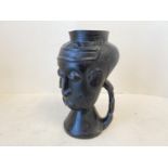 Congolese Kuba carved wine cup, with three typical stylised faces and figural handle 8.5” inches