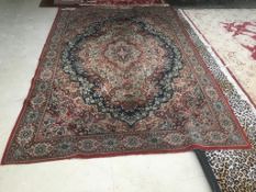 Old traditional blue ground woollen rug with all over red and fawn stylised pattern 285 x 197