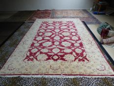 Modern handmade Ziegler carpet, plum central panel decorated with large stylised flowers with a wide