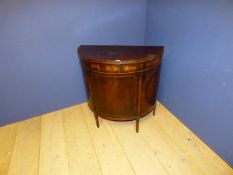 Georgian mahogany demilune table, with cupboard beneath supported by slender sabre legs 83cmL