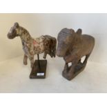 Decorative model of a horse on a wooden plinth and a cow