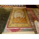 Fine quality modern silk rug, the central soft green panel, with exotic birds and deer in a