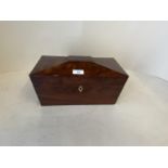 Figured mahogany tea caddy with lion mask ring handles and fitted interior with glass mixing bowl.