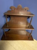 Georgian mahogany three tiered wall hanging shelf supported by slender carved supports and carved