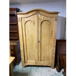 Antique Pine serpentine topped, two door wardrobe opening to reveal hanging rail and shelves. 191cmH