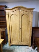 Antique Pine serpentine topped, two door wardrobe opening to reveal hanging rail and shelves. 191cmH