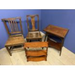 Two oak solid seat hall chairs, a mahogany hanging shelf, and a mahogany swivel top games table,