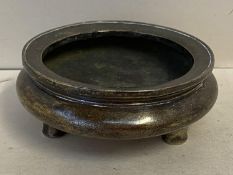 A Chinese circular bronze shallow censer on 3 feet and seal mark to base 9.5 cm dia 506gms