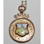 Gold football medal. 9ct gold medal with colour enamel shield decoration of a footballer to front.