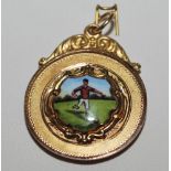Gold football medal. 9ct gold medal with colour enamel shield decoration of a footballer to front.