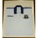 'Per Angusta Ad Augusta'. A white rugby shirt with emblem in white blue and yellow in shield to