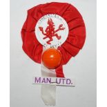Manchester United. Attractive and early rosette in red and white ribbon with centre image of a '