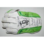 Signed wicket-keeping glove. One new Kookaburra wicket-keeping glove, signed by eleven former