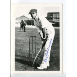 Don Bradman. Mono photograph of Bradman, wearing cricket attire and cap, in batting pose in front of