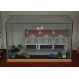 A scratch built scale replica of Reliance Garage, with diecast models, all in glazed case, case w.