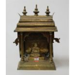 An Eastern brass pagoda with inset deity, h.42cm