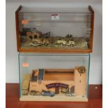 A scale model of a fort with diecast support vehicles, in glazed display case, w.30cm; and one other