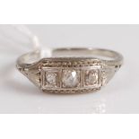 An Art Deco platinum and diamond set three stone ring, the centre set old cut diamond weighing