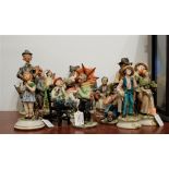 A collection of Capo di Monte figures, to include boy in blue with knapsack, man with orange