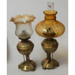 A pair of Victorian style cast brass lamps, each fitted for electricity and disguised as oil lamp,