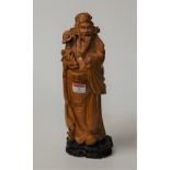 An Oriental hardwood carving of a scholar, on plinth, h.33cm