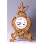 A 19th century French gilt bronze Rococo Revival mantel clock, the whole surmounted with a musical