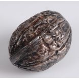 A contemporary silver pill-box, naturalistically worked in the form of a walnut with hinged