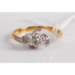 An 18ct gold diamond three-stone ring, the small old cuts each illusion set, 3.6g, size L/M