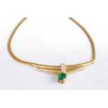 A modern 18ct gold necklet, centre set with an oval cut emerald weighing approx 0.25 carats, over