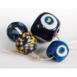 Four various Japanese blown glass beads, the largest w.3cm
