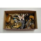 A box of miscellaneous costume jewellery, to include paste set leaf brooches, enamelled butterfly