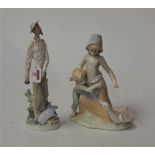 A Spanish porcelain figure group of two children and a goose, height 28cm, together with a Lladro