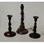 A pair of oak barleytwist candlesticks, h.20cm; together with an oak barleytwist lampbase (2)