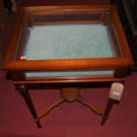 A mahogany and glazed hinged top bijouterie table, raised on turned tapering supports, w.56.5cm