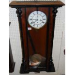 An early 20th century walnut and ebonised Vienna droptrunk wall clock, with single weight and
