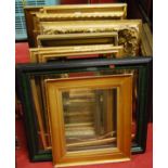 A collection of picture frames, largely being gilt gesso but to include ebonised examples, some