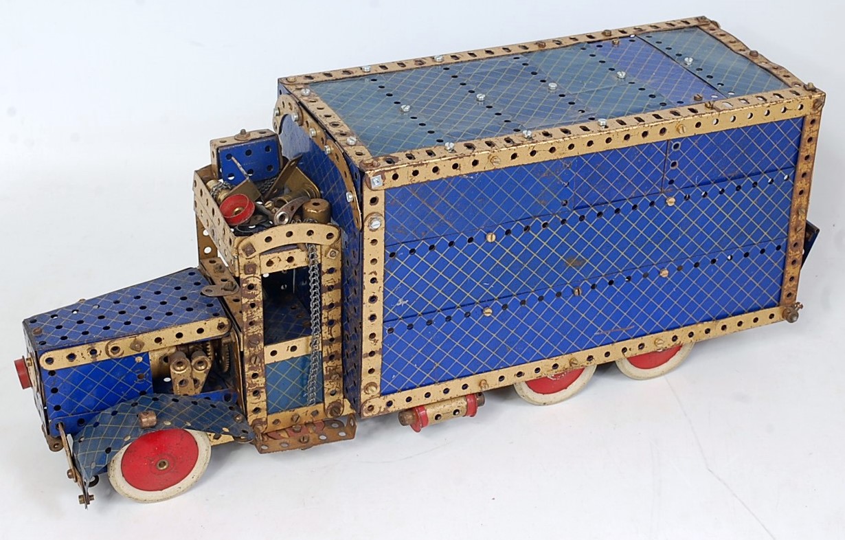 Two blue & yellow and gold Meccano home built models of a delivery van, and a landspeed record