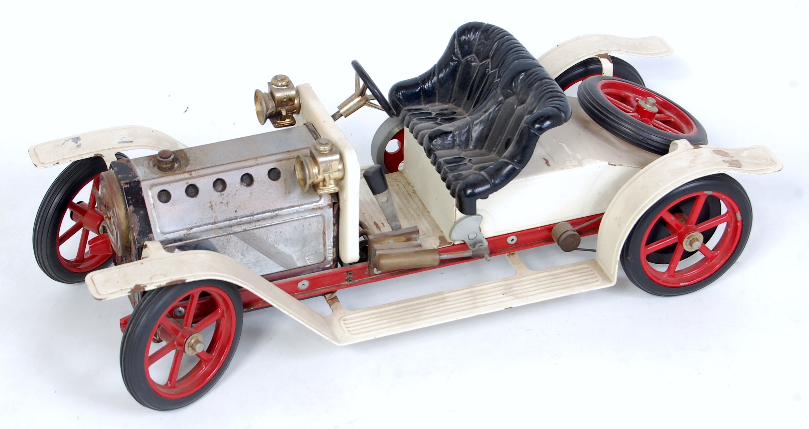 A Mamod SR1 steam roadster comprising white and red body with black seat, used example (loose)